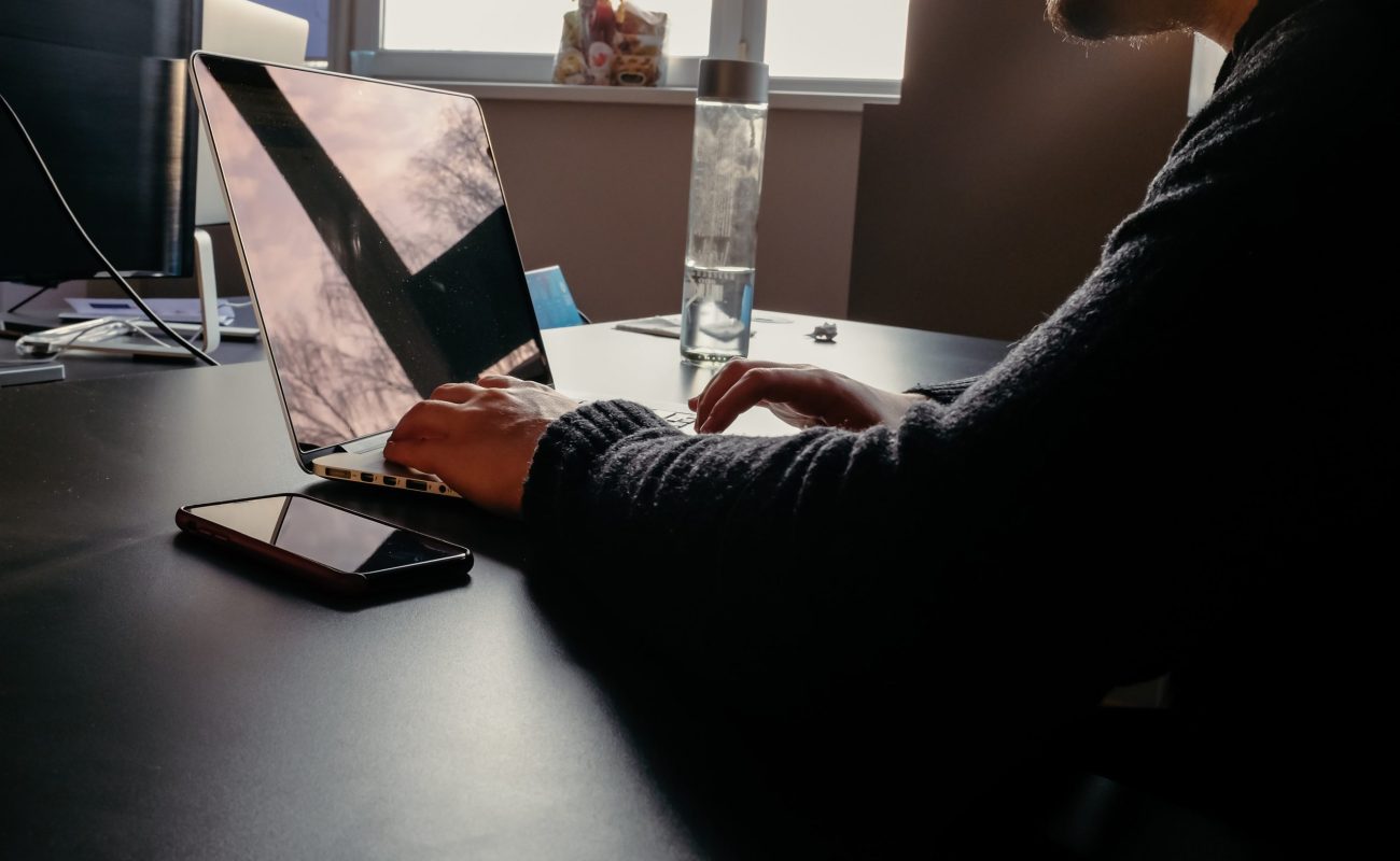 A man works at a computer in the office A man works at a computer in the office